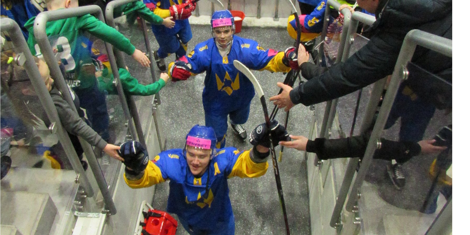 Ukrainian fans congratulate the team after they beat South Korea 4-0 at the Olympic hockey qualification tournament in Sosnowiec, Poland. (Photo: Joel Wassserman)